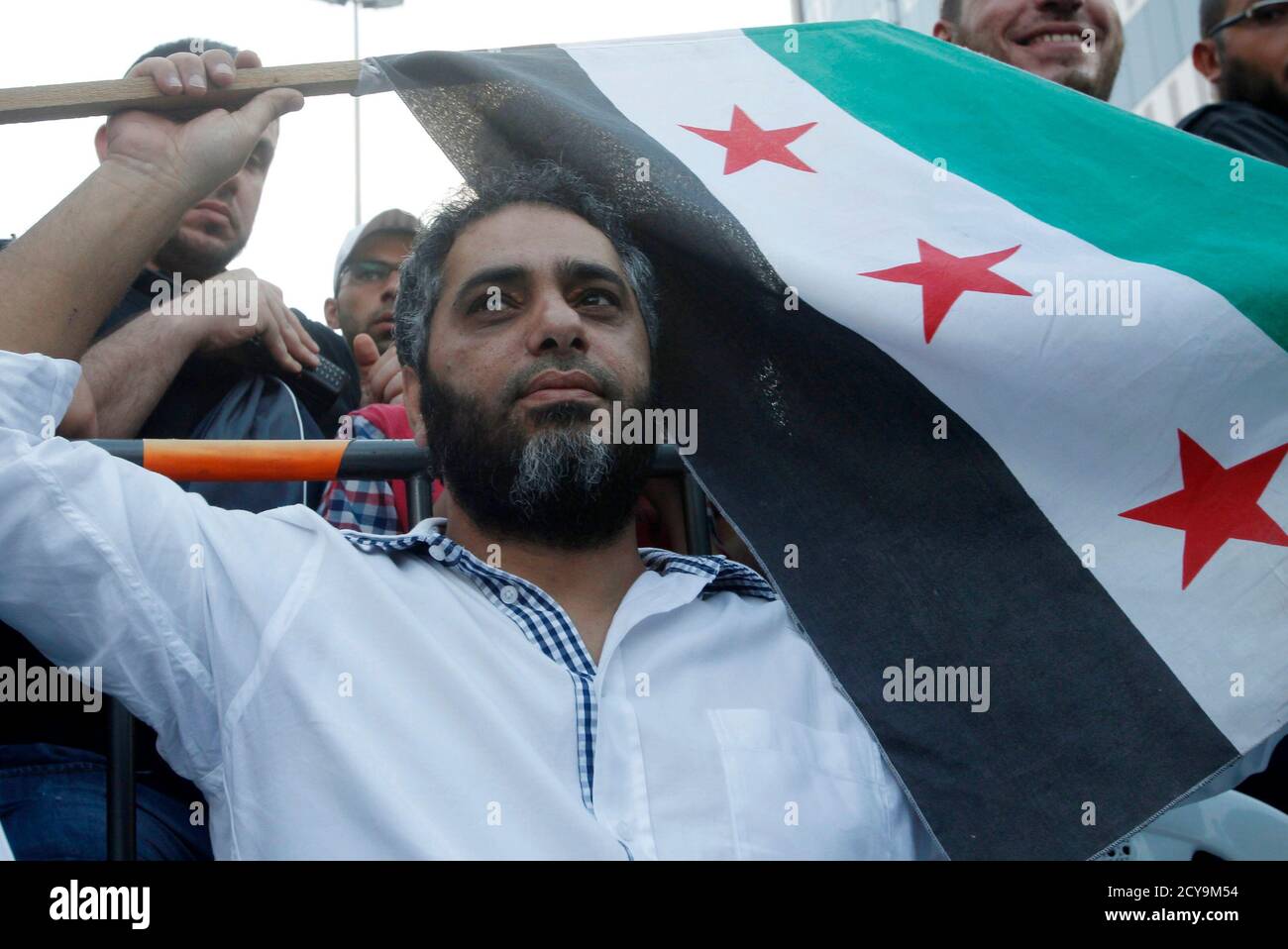 Lebanese singer Fadel Shaker waves a Syrian opposition flag as he takes  part in a protest organized by Sunni Muslim Salafist leader Ahmad al-Assir,  against the Syrian regime in Sidon, southern Lebanon