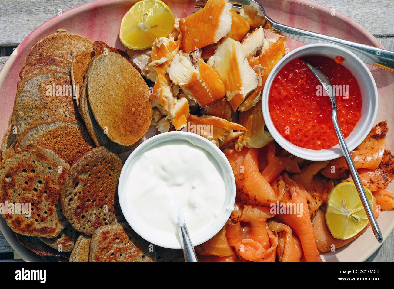 Smoked fish platter with salmon roe, lox, smoked trout, sour cream, and
