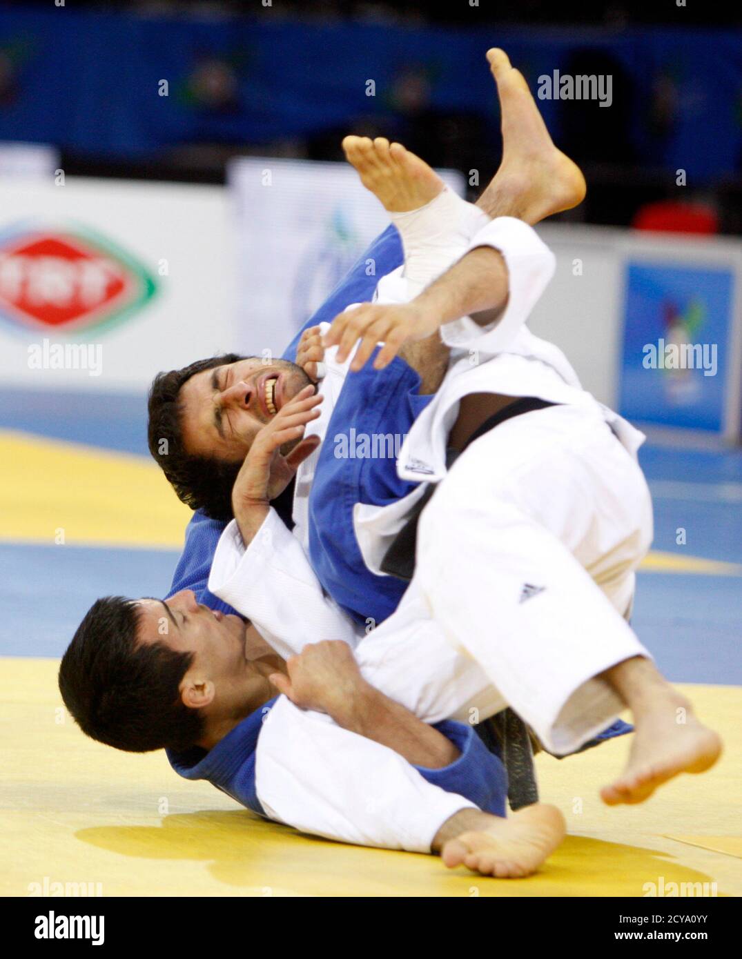 Ukraine's Georgii Zantaraia (in blue) and Georgia's Betkil Shukvani compete during their men's under 60 kg final match at the Judo European Championships in Istanbul April 21, 2011. REUTERS/Osman Orsal (TURKEY - Tags: SPORT JUDO) Stock Photo