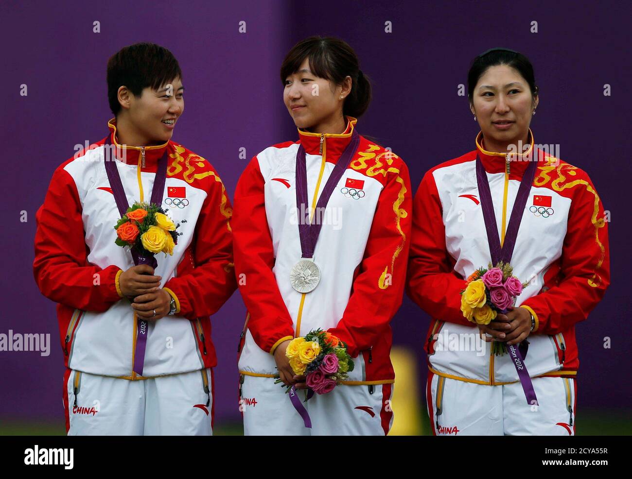 China's archers (L-R) Cheng Ming, Fang Yuting and Xu Jing celebrate with their silver medals after their women's archery team match against South Korea at the Lords Cricket Ground during the London 2012 Olympic Games July 29, 2012. REUTERS/Suhaib Salem (BRITAIN  - Tags: SPORT OLYMPICS SPORT ARCHERY) Stock Photo