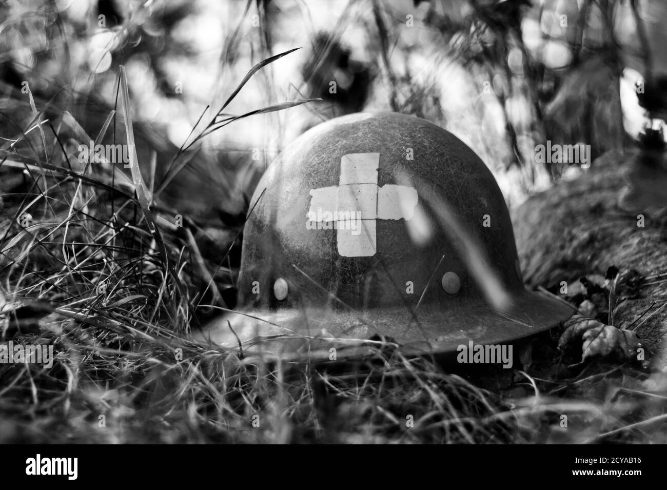 WW2 medic style helmet in the dirt in black and white Stock Photo