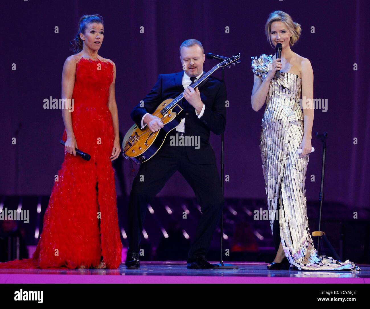 German TV entertainers and Eurovision Song Contest hosts Anke Engelke, Stefan Raab and Judith Rakers (L-R) perform during a rehearsal in Duesseldorf May 13, 2011. The 2011 Eurovision Song Contest final will be held in the western German city of Duesseldorf on May 14.  REUTERS/Wolfgang Rattay (GERMANY  - Tags: ENTERTAINMENT) Stock Photo