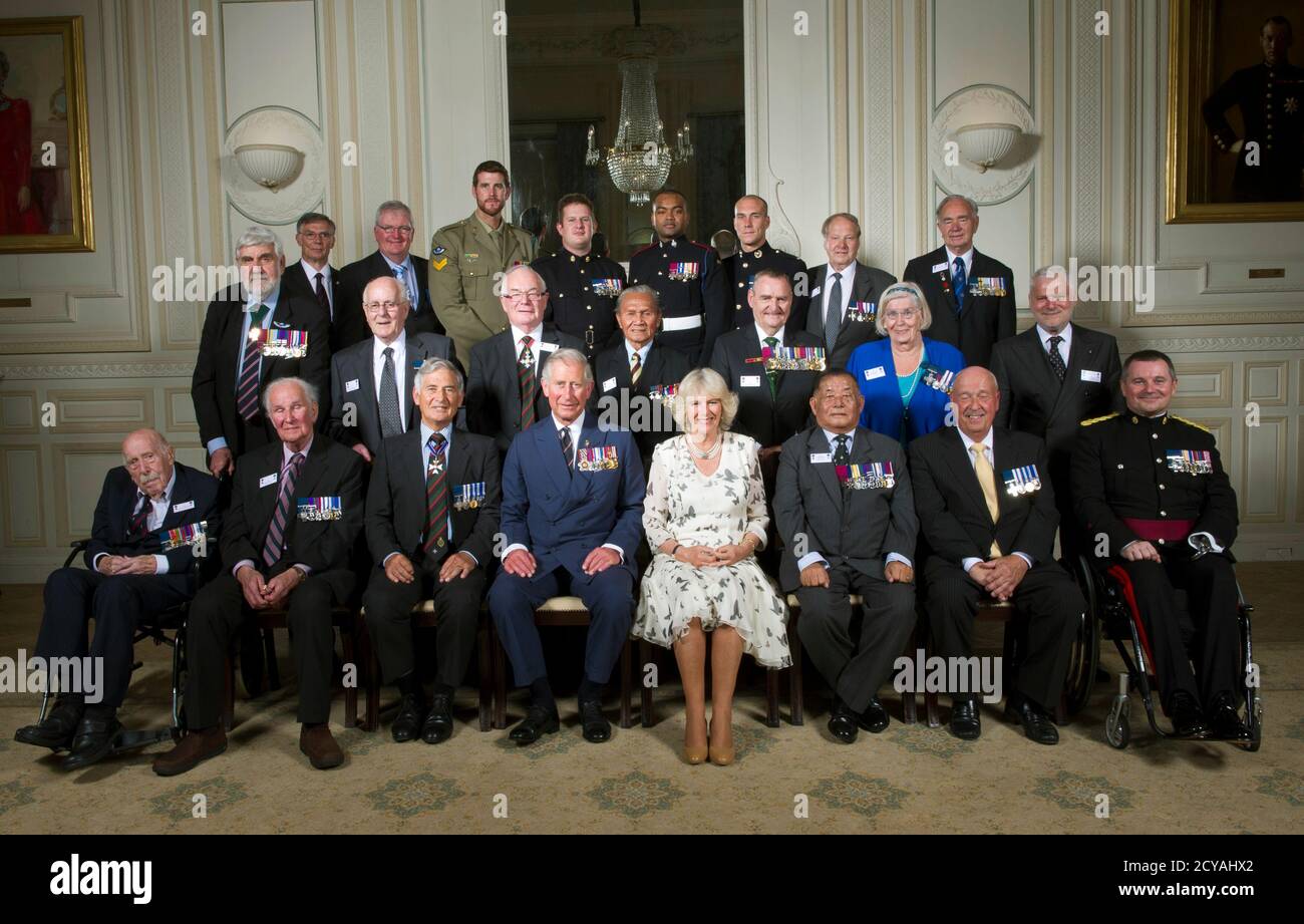 Britain's Prince Charles (front row 4th L), president of The Victoria Cross and George Cross Association, and his wife Camilla, Duchess of Cornwall (front row 4th R) pose with Victoria and George Cross holders during a reception at the In & Out club in London May 30, 2012. Back row (L-R) Barry Johnson GC, Michael Pratt GC, Ben Roberts-Smith VC, Kim Hughes GC, Johnson Beharry VC, Matt Croucher GC, Jack Bamford GC, Alfred Lowe GC. Middle row (L-R) Bill Speakman VC, Henry Flintoff GC, Jim MacDonald GC, Awang Anak Raweng GC, Keith Payne VC, Margaret Purves GC, Joseph Zammit Tabona GC. Front row (L Stock Photo