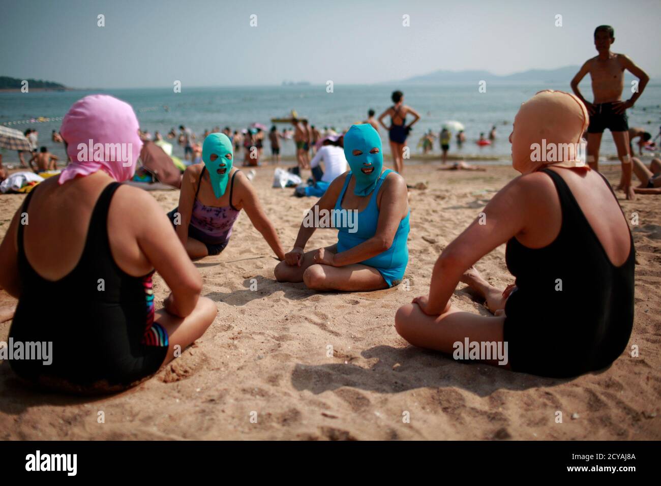 Women Wearing Nylon Masks Chat As They Rest On The Shore During Their Visit To A Beach In Qingdao Shandong Province July 6 12 The Mask Which Was Invented By A Woman