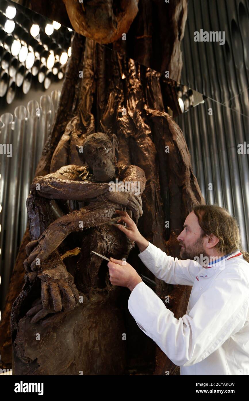 French chocolate maker Patrick Roger works on a five-metre high chocolate  tree and chocolate monkey creations in his shop in Paris November 15, 2012.  Roger puts the final touches to an estimated