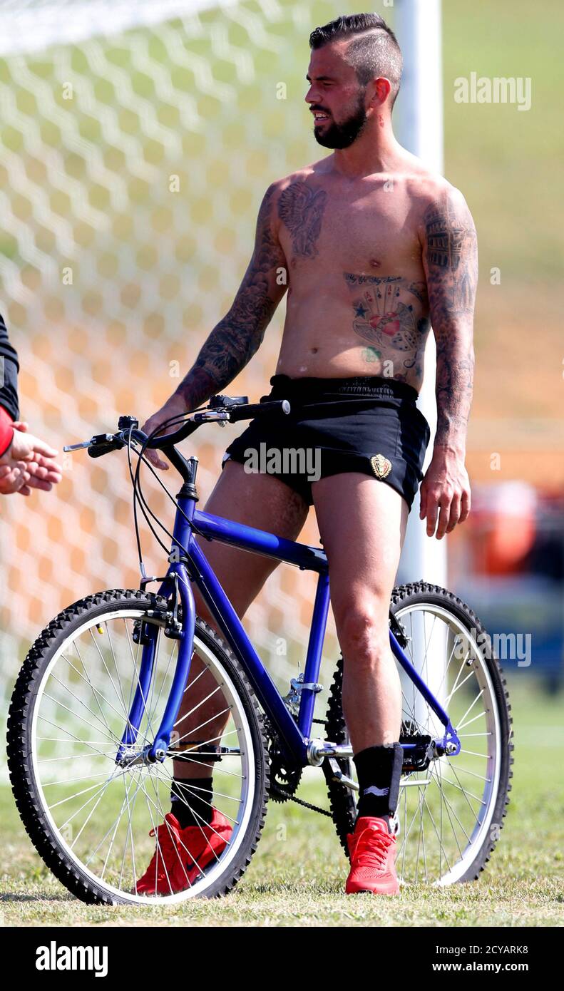 Belgium's national soccer player Steven Defour prepares to ride his bike  after a team training session in Mogi das Cruzes June 18, 2014.  REUTERS/Paulo Whitaker (BRAZIL - Tags: SPORT SOCCER WORLD CUP