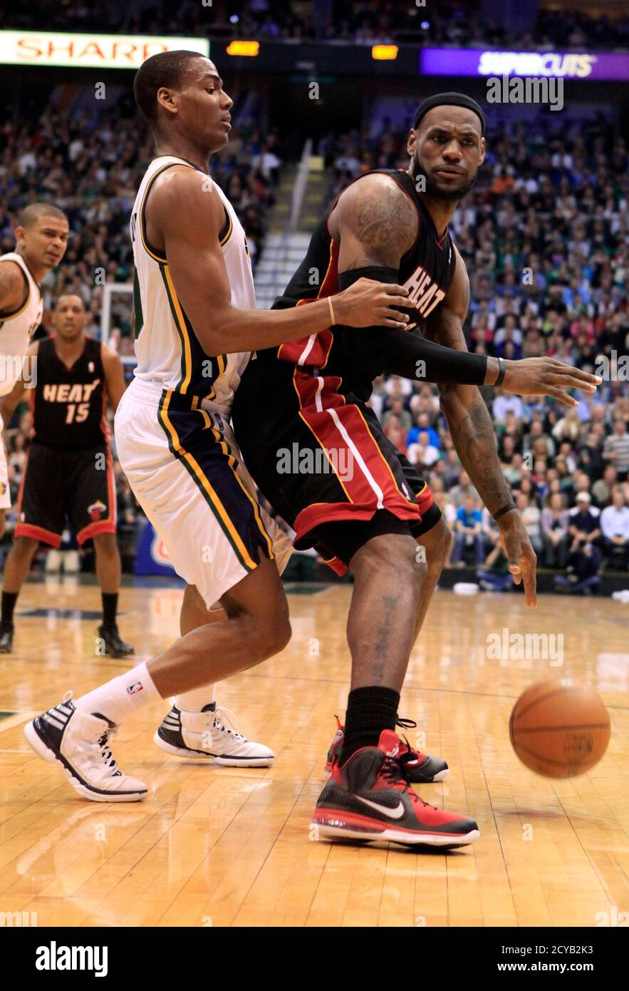 Miami Heat forward LeBron James (R) is defended by Utah Jazz guard Alec  Burks during the first half of their NBA basketball game in Salt Lake City,  Utah March 2, 2012. REUTERS/Jim