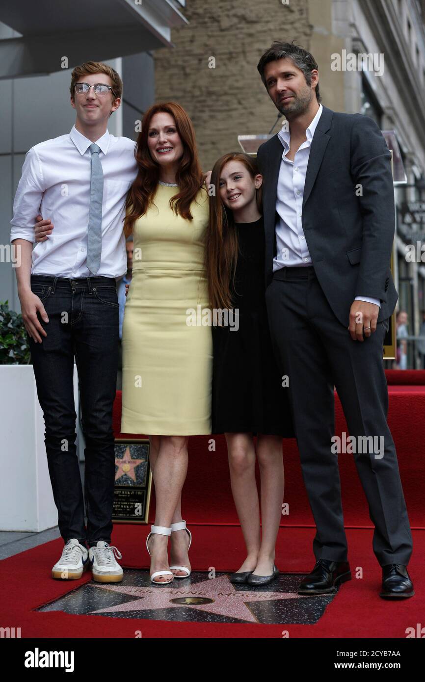 Actress Julianne Moore (2nd L) poses with her husband Bart Freundlich (R) and their children, Caleb and Liv, on her star after it was unveiled on the Walk of Fame in Hollywood, California October 3, 2013.   REUTERS/Mario Anzuoni  (UNITED STATES - Tags: ENTERTAINMENT) Stock Photo