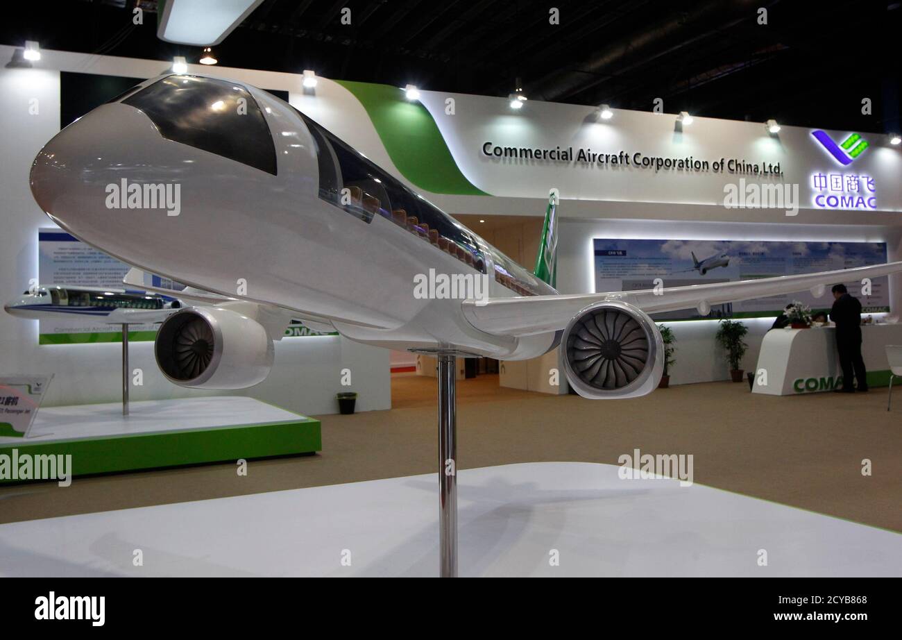 A Commercial Aircraft Corporation of China (COMAC) C919 aircraft is displayed at their booth at the Singapore Airshow February 12, 2014. Chinese planemaker COMAC is learning the hard way as it tries to compete with heavyweights Airbus and Boeing in developing a narrow-body aircraft, apparently exposed to the perils of the supply chain and program management issues. Picture taken February 12, 2014. REUTERS/Edgar Su (SINGAPORE - Tags: TRANSPORT BUSINESS) Stock Photo