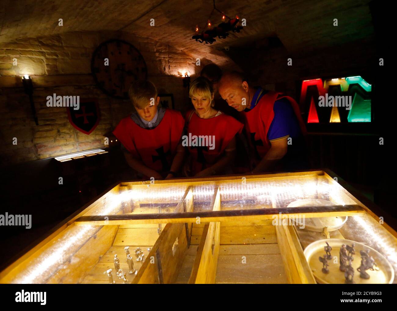 Players try to resolve a puzzle in the medieval escape room at TRAP in  Budapest August 1, 2014. In a ramshackle old building in Budapest, tourists  pay to be locked up in