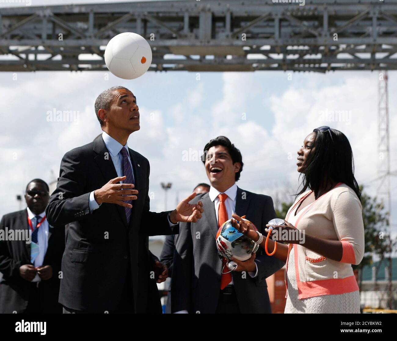 U.S. President Barack Obama heads a soccer ball at Ubungo Power Plant in  Dar es Salaam July 2, 2013. The ball called a "soccket ball" has internal  electronics that allows it to
