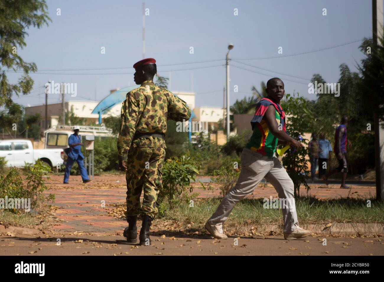 A protester leaves the state TV headquarters in Ouagadougou, capital of Burkina Faso, November 2, 2014. Gunfire rang out on Sunday at the headquarters of Burkina Faso's state-run RTB Television as the broadcaster went off air, a Reuters witness said, amid a power struggle following the resignation of long-ruling President Blaise Compaore. The gunshots were fired into the air and there was no immediate sign of injuries.  REUTERS/Joe Penney (BURKINA FASO - Tags: CIVIL UNREST POLITICS MILITARY) Stock Photo