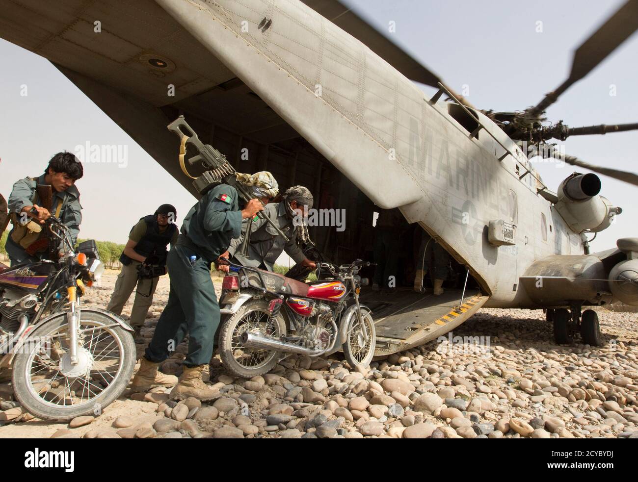 Members of Afghan National Police (ANP) board with motorcycles on a U.S. Marines CH-53E Super Stallion helicopter for a Western Engagement operation at the Camp Gorgak in Helmand province, southern Afghanistan, July 7, 2011. U.S. Marines and Afghan security forces conducted a joint operation aiming to extend their presence west of Helmand river.    REUTERS/Shamil Zhumatov  (AFGHANISTAN - Tags: POLITICS MILITARY TRANSPORT IMAGES OF THE DAY) Stock Photo