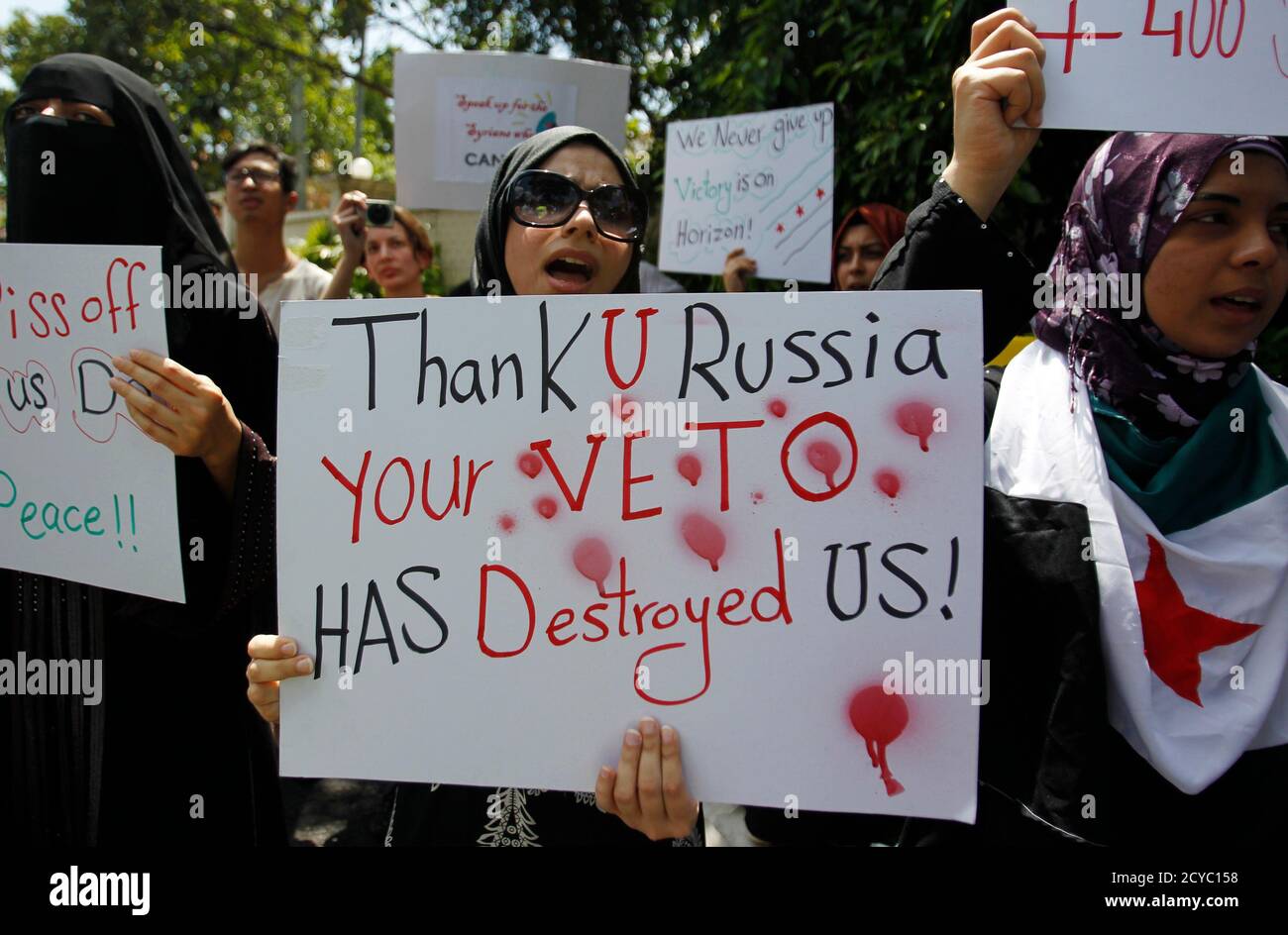 Syrians Living In Malaysia Shout Slogans As They Hold Placards During A Rally In Support Of Syrian Anti Government Protesters Outside The Syrian Embassy In Kuala Lumpur February 10 2012 Tanks Amassed Outside
