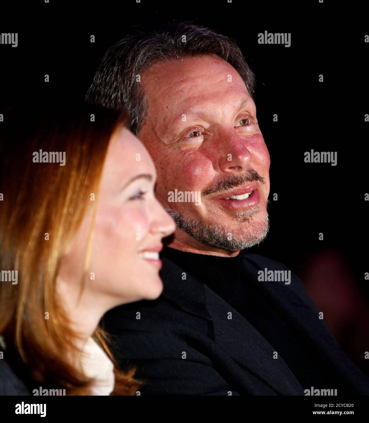 Oracle CEO Larry Ellison and his wife, Melanie, watch a film clip of  Ellison's America's Cup victory prior to his keynote address at Oracle Open  World in San Francisco, California September 22,