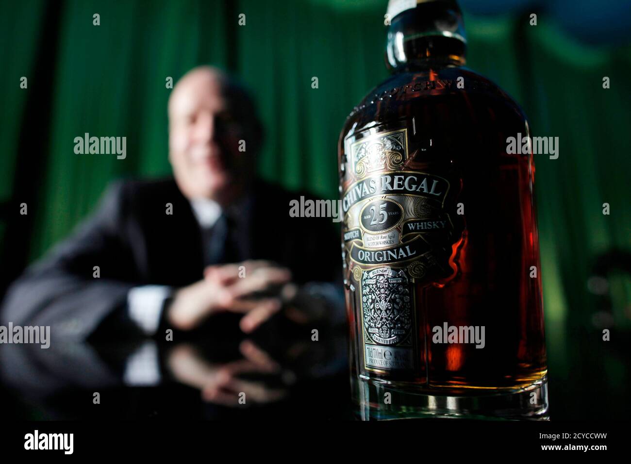 A bottle of Chivas Regal sits on a table in front of Darren Hosie, regional manager of Chivas Brothers, as he is interviewed by Reuters in Shanghai in this December 8, 2010 file photo.  Born and bred in Glasgow, 37-year-old Hosie has spent the past seven years working for scotch whisky giant Pernod Ricard and since August 2007, he has lived in China as international brand ambassador for the firm's top whisky brands Chivas Regal, Ballantine's and The Glenlivet. Hosie is well accustomed to the tastes and whims of the country's new business elite -- the legions of bankers, entrepreneurs, traders  Stock Photo