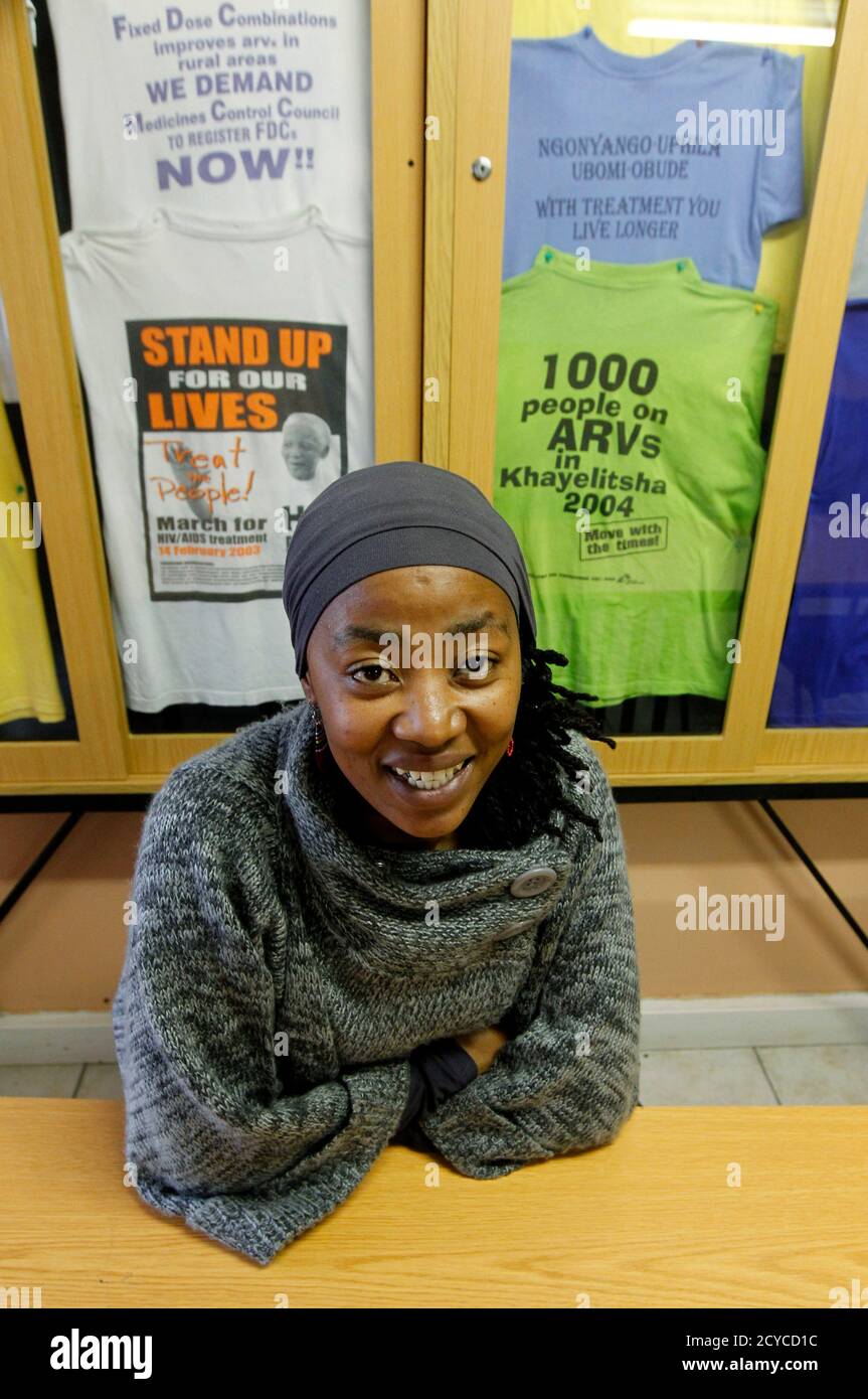 AIDS activist Vuyiseka Dubula sits beneath t-shirts in the offices of the Treatment Action Campaign in Cape Town's Khayelitsha township May 31, 2011. Dramatic scientific advances since HIV was first discovered 30 years ago this week mean the virus is no longer a death sentence. Thanks to tests that detect HIV early, new antiretroviral AIDS drugs that can control the virus for decades, and a range of ways to stop it being spread, 33.3 million people around the world are learning to live with HIV.  To match Special Report AIDS/ Picture taken May 31, 2011.   To match Special Report AIDS/    REUTE Stock Photo