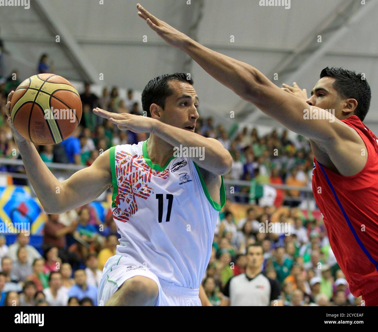 Omar Quintero of Mexico (L) goes up to shoot past Manuel Narvaez of Puerto  Rico during their men's final basketball game at the Pan American Games in  Guadalajara October 30, 2011. REUTERS/Lucy