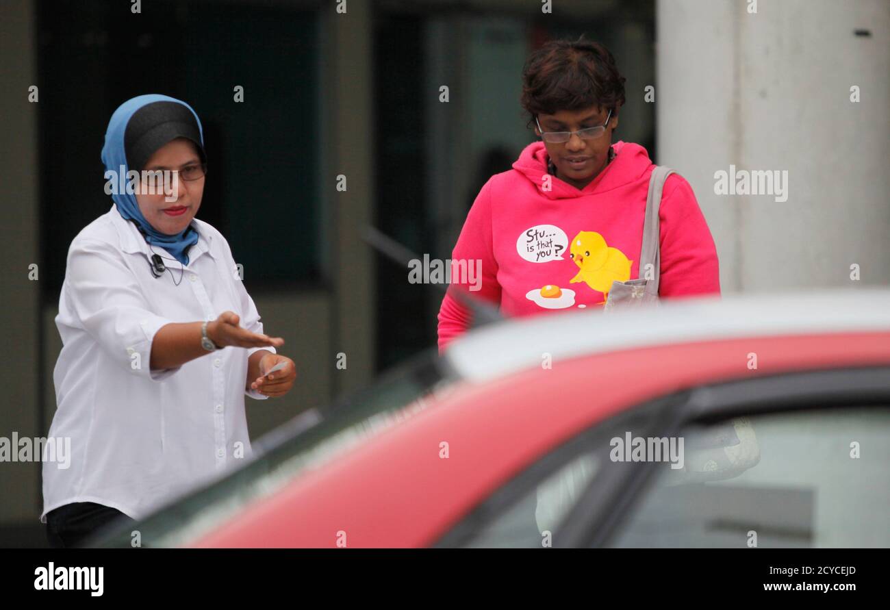 Women S Only Taxi Driver Asnima Aminudin L Leads Her Passenger At A Taxi Stand In Putrajaya Outside Kuala Lumpur December 2 2011 Malaysia Has Launched Women S Only Taxis Cabs By Women Drivers
