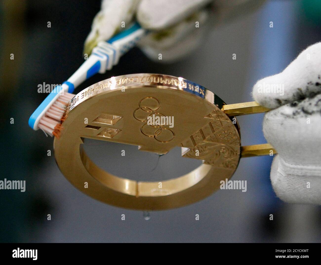 An Employee Uses A Brush To Clean A Bronze Medal Manufactured For The 2014 Winter Olympic Games In Sochi At The Adamas Jewellery Factory In Moscow June 28 2013 The Factory Is How to tape an ankle. alamy