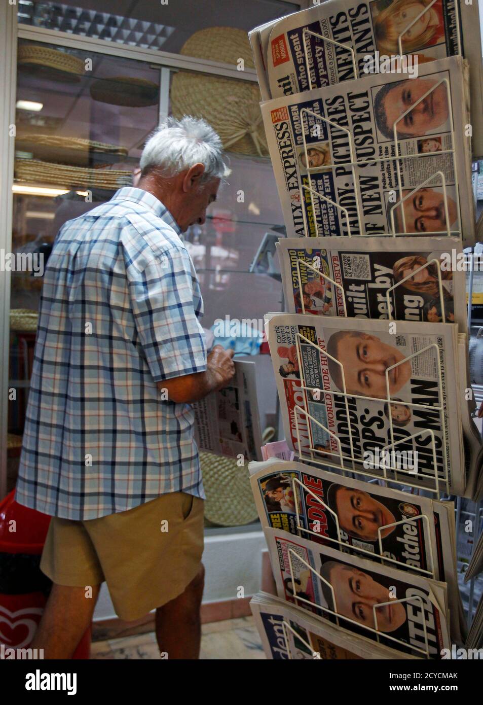 A Man Walks Past A Newspaper Stand Displaying British Newspapers Mostly With Frontpages Showing E Fit Images Of Individuals British Police Say They Want To Question In Relation To Madeleine Mccann S Disappearance In