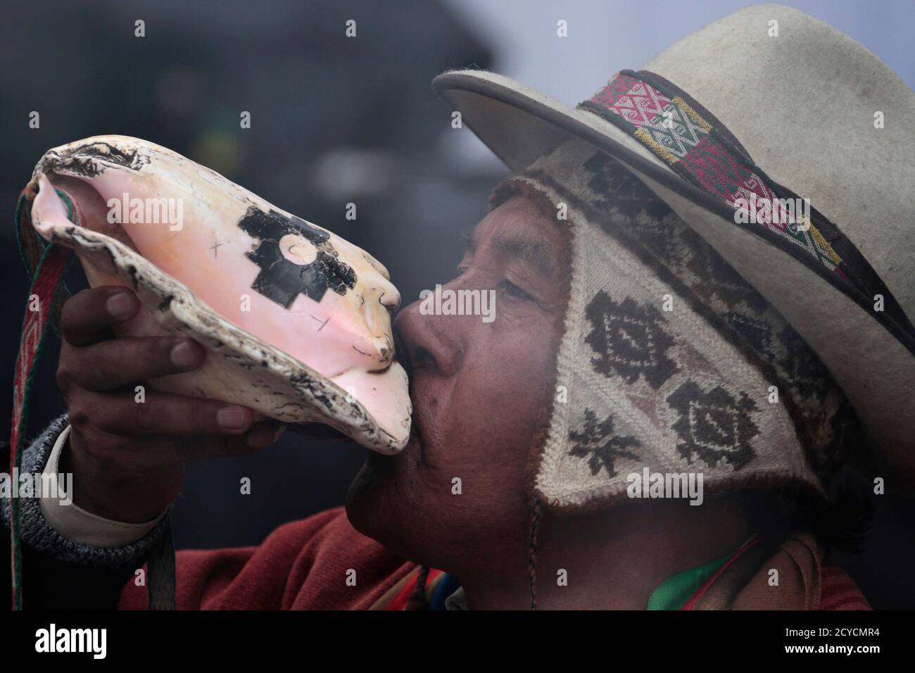 A Bolivian witch doctor blows a shell during the launch of the Tupac Katari  satellite in La Paz December 20, 2013. China Great Wall Industry  Corporation launched Tupac Katari, Bolivia's first communications