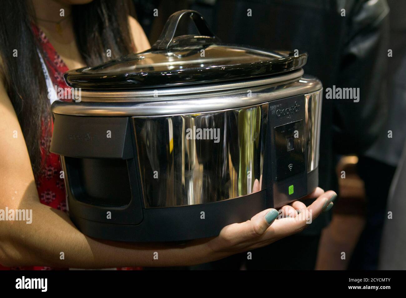 A Belkin Crock-Pot WeMo Smart Slow Cooker ($99.99) is displayed during 'CES Unveiled,' a media preview event to the annual Consumer Electronics Show (CES), in Las Vegas, Nevada, January 5, 2014. The crock-pot can be controlled remotely via a smartphone. The appliance should be available in March, a representative said. REUTERS/Steve Marcus (UNITED STATES - Tags: BUSINESS SCIENCE TECHNOLOGY) Stock Photo