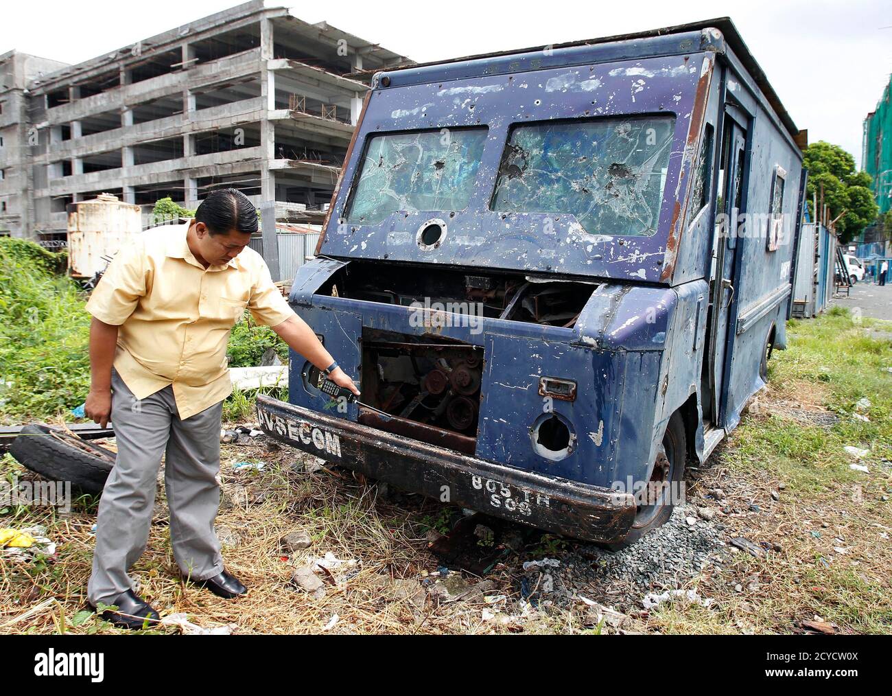 A Chief Security Guard Points To The Number Of An Aviation Security Command Avsecom Van Which Was Used To Haul The Body Of Martyred Hero Benigno Ninoy Aquino Jr After He Was