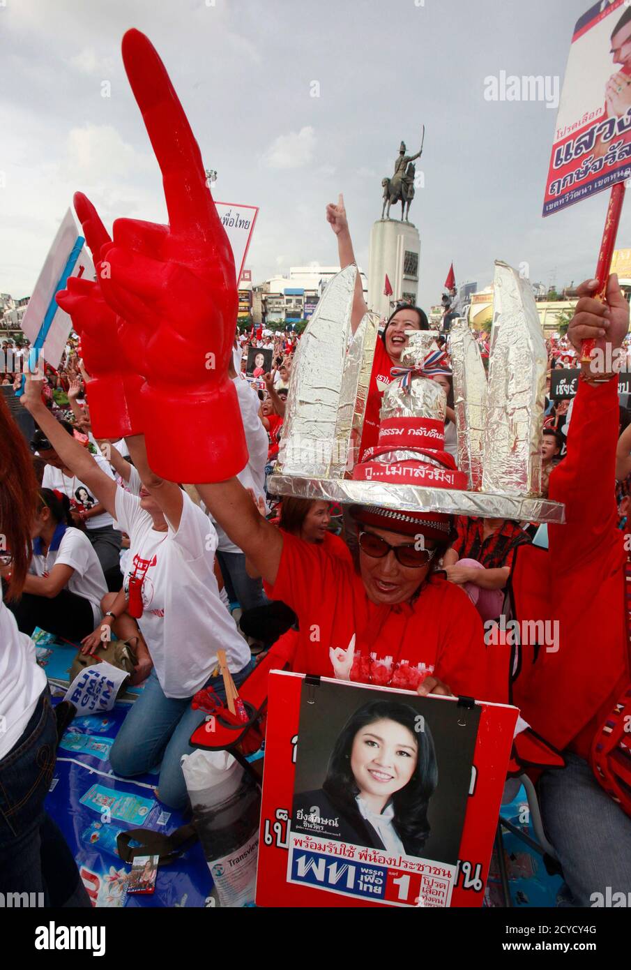 A supporter of the country's biggest opposition Puea Thai Party holds a portrait of prime ministerial candidate Yingluck Shinawatra, the sister of toppled former Thai premier Thaksin Shinawatra, during an election campaign in Bangkok June 18, 2011. Thais will go to the polls on July 3 for a general election.   REUTERS/Chaiwat Subprasom  (THAILAND - Tags: POLITICS ELECTIONS) Stock Photo