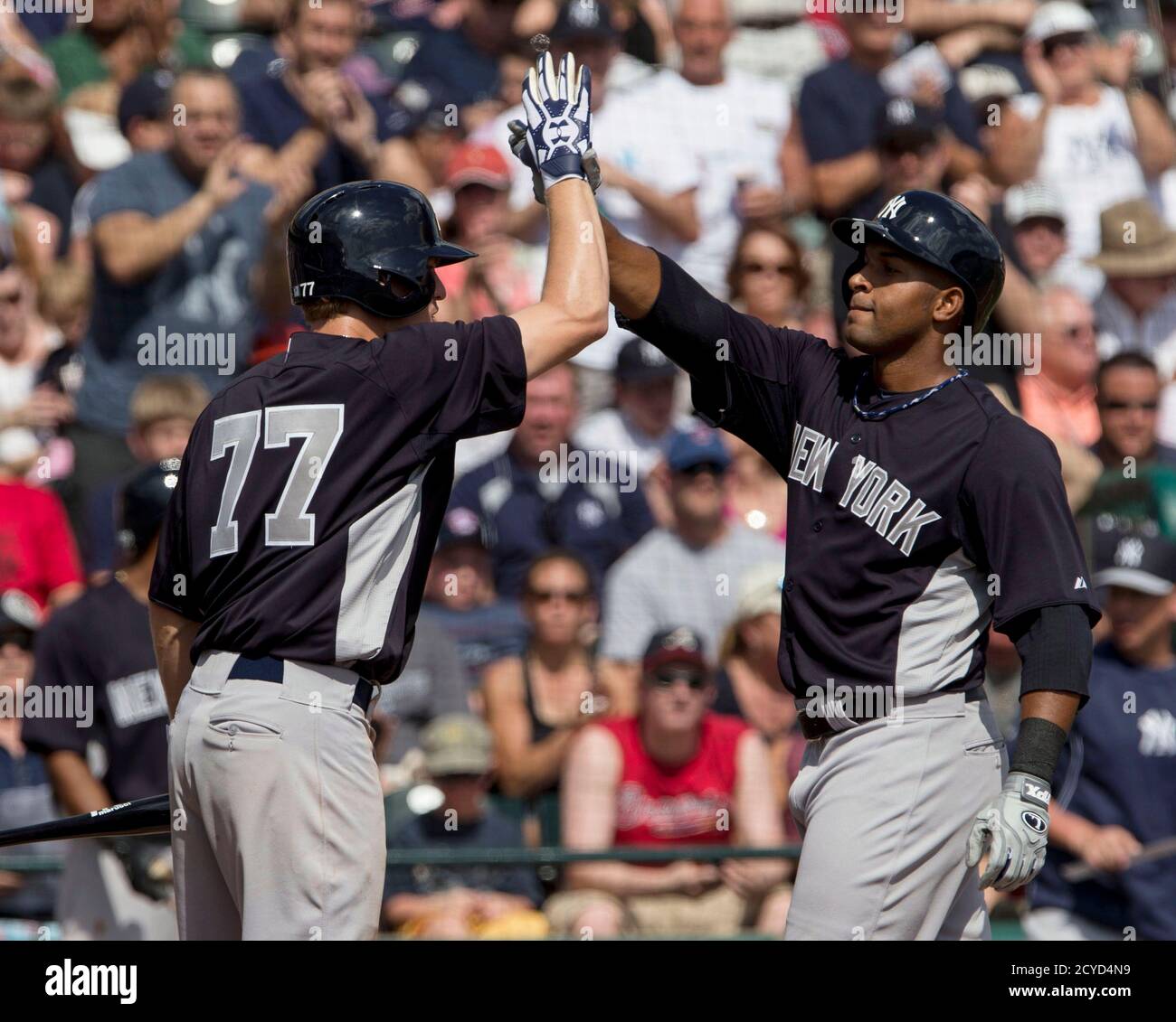 New York Yankees' Zoilo Almonte (R) celebrates his home run with teammate Corban Joseph during the third inning of their MLB spring training game against the Atlanta Braves in Lake Buena Vista, Florida, February 23, 2013. REUTERS/Scott Audette   (UNITED STATES - Tags: SPORT BASEBALL) Stock Photo
