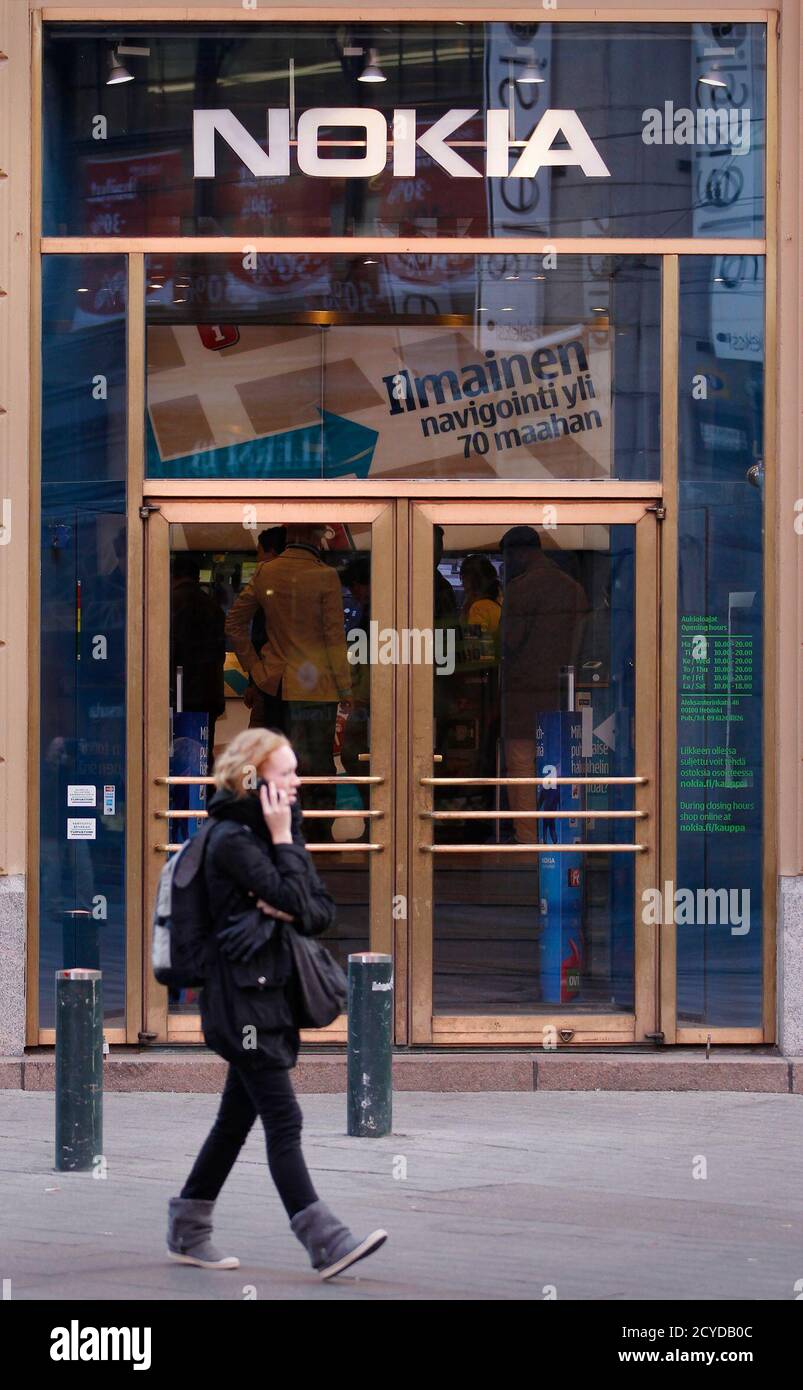 A pedestrian walks past the Nokia flagship store in Helsinki September 29, 2010. The world's leading cellphone maker, Nokia, said on Thursday it has started to ship its flagship smartphone model the N8, boosting its share price. Picture taken September 29. REUTERS/Bob Strong  (FINLAND - Tags: BUSINESS) Stock Photo
