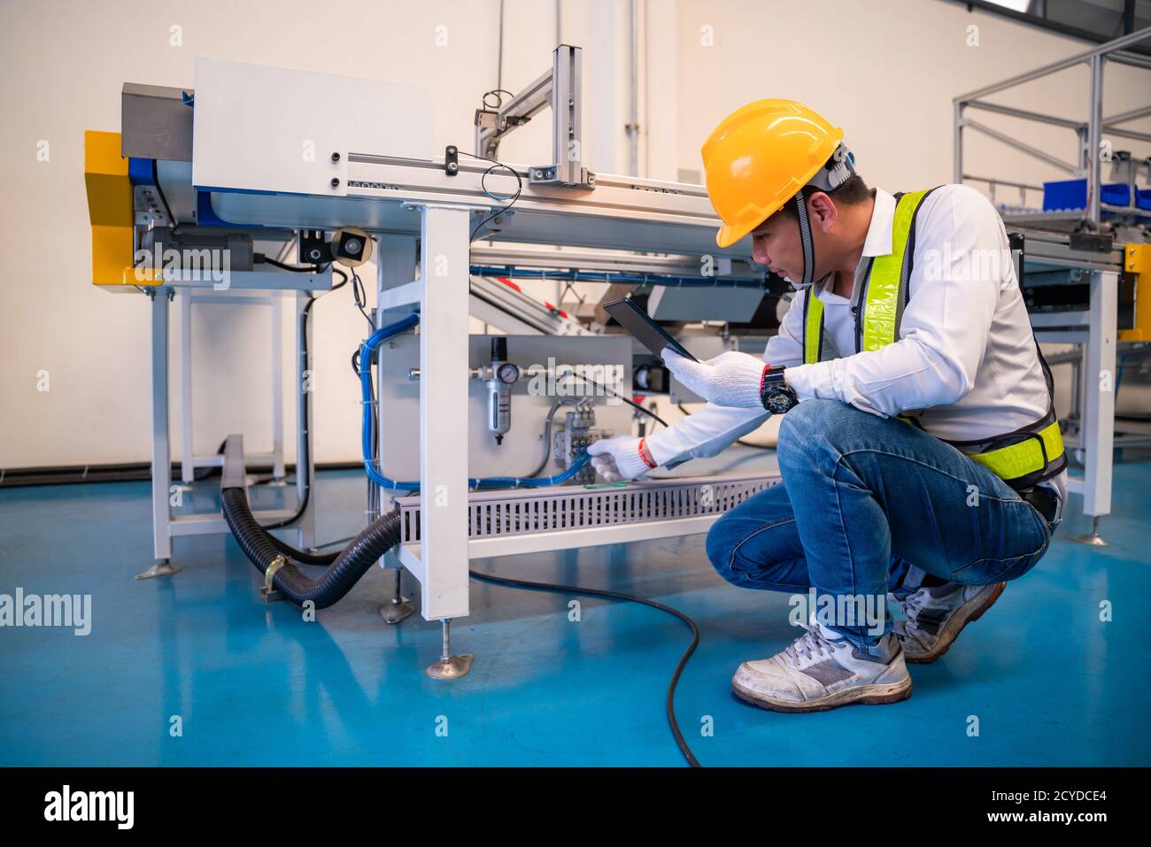 Asian man Mechanic technician worker working install and checking the