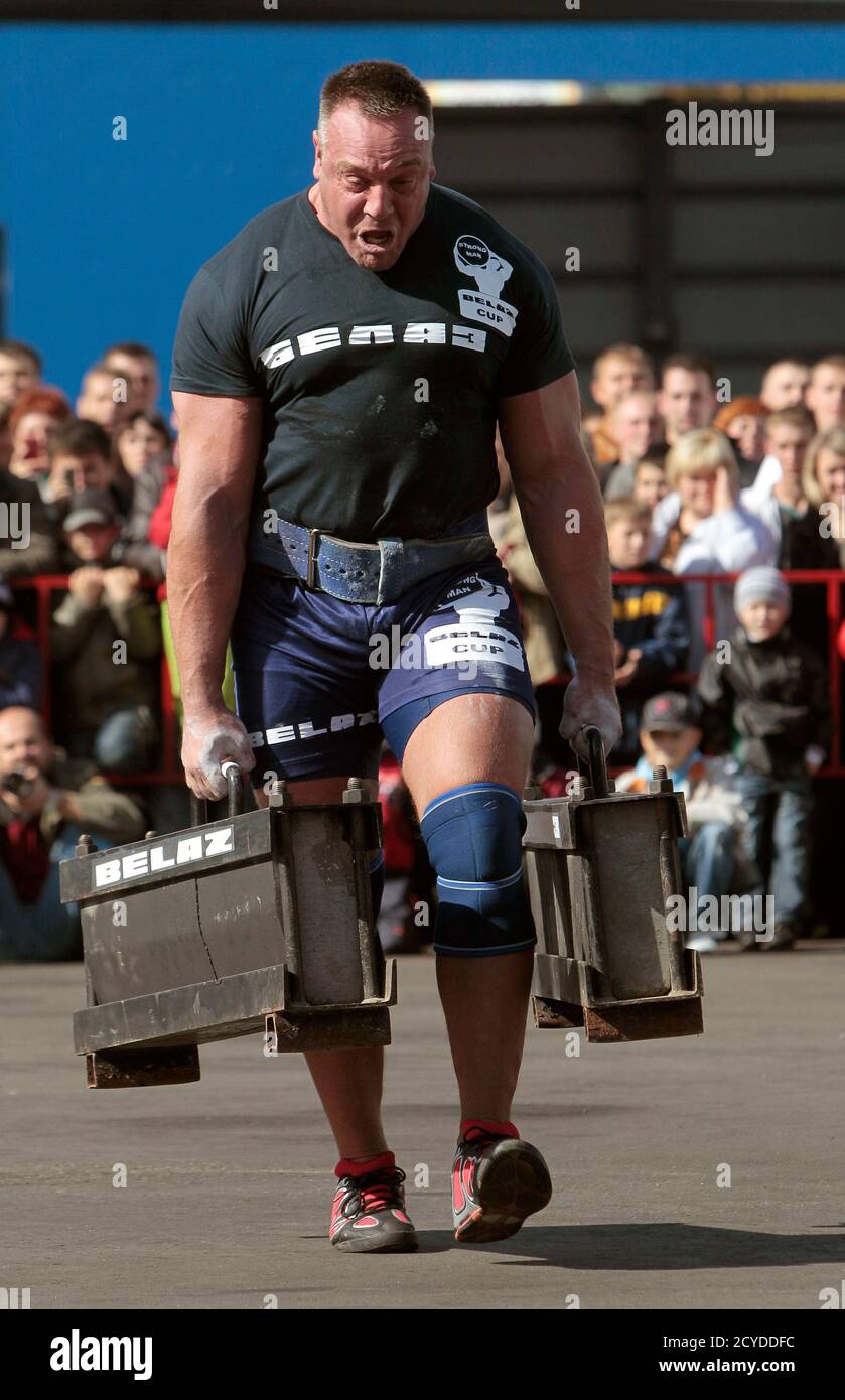 Richard van der Linden from the Netherlands carries 270 kg (595 lbs)  weights during an open day at the "Belarussian Autoworks" (BELAZ) plant on  "Mechanician Day" in the town of Zhodino, some