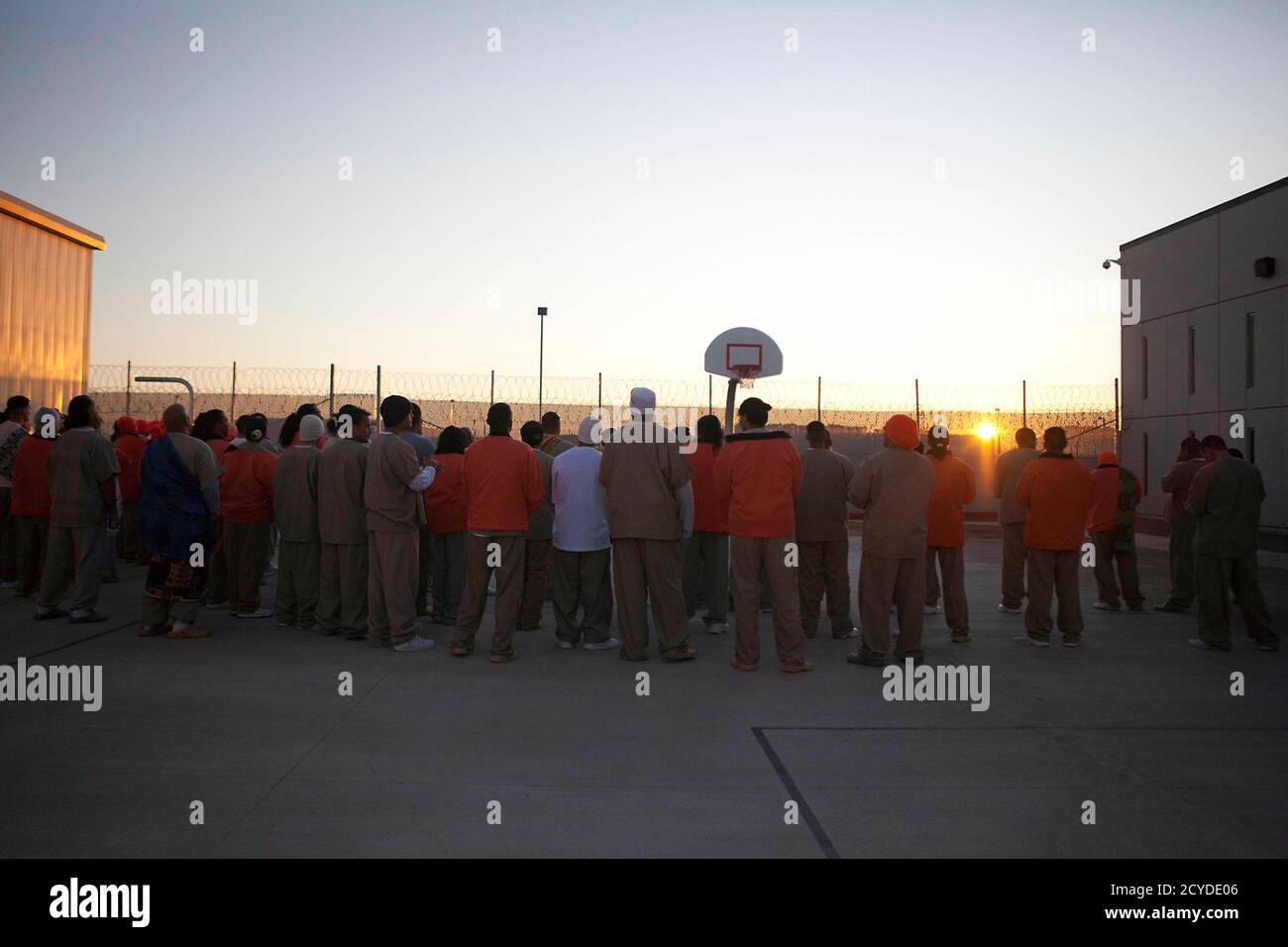 Inmates welcome the sun in celebration of the Makahiki season, the ancient Hawaiian New Year, at the Sahuaro Correctional Center in Eloy, Arizona November 9, 2011. Two spiritual leaders from Hawaii visited the prison to teach and enlighten Hawaiian inmates of their culture. The facility in Arizona currently houses prisoners from Hawaii. REUTERS/Samantha Sais (UNITED STATES - Tags: CRIME LAW SOCIETY) Stock Photo