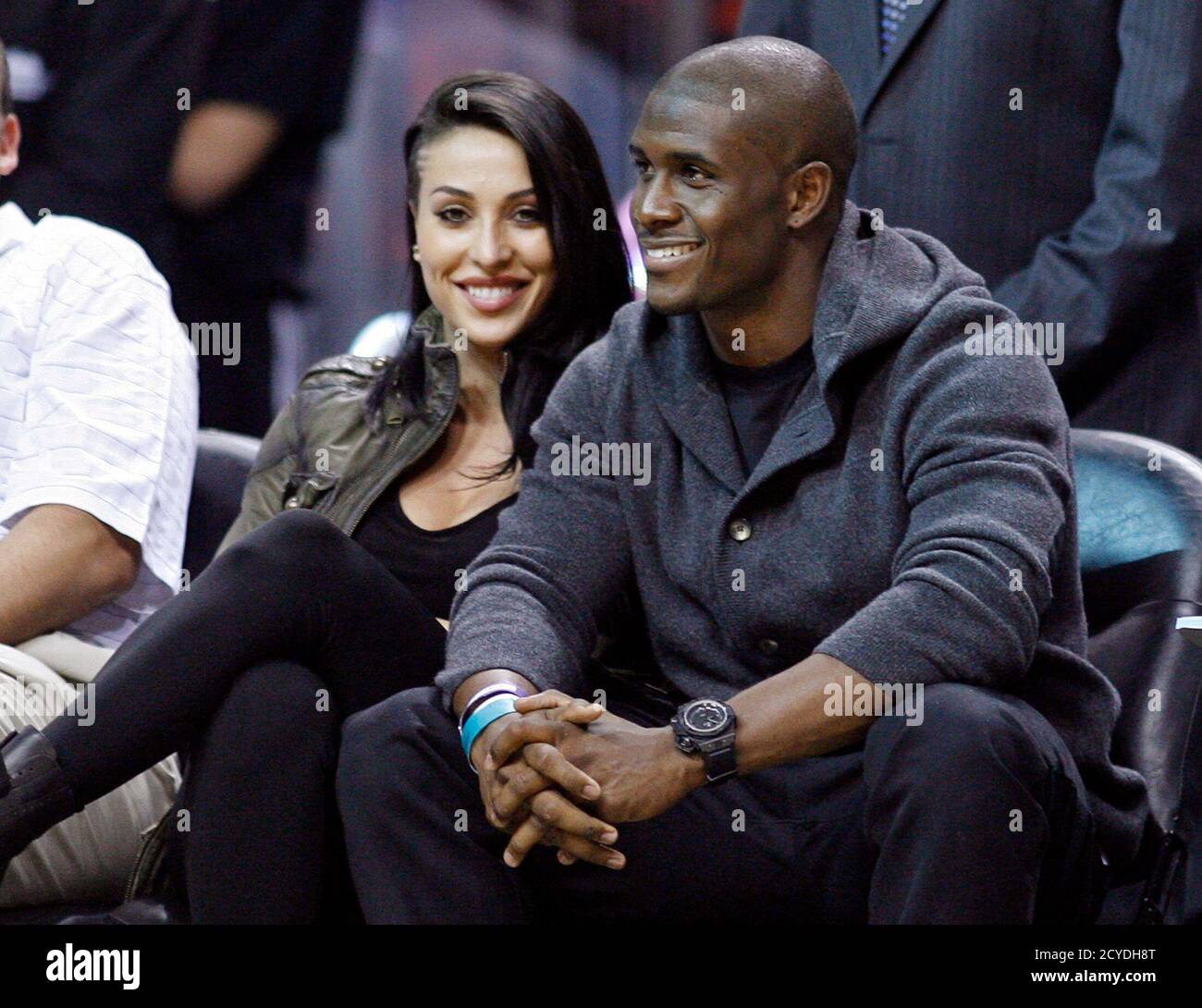 Miami Dolphins running back Reggie Bush sits courtside with Lilit Avagyan as the Miami Heat met the Boston Celtics in their NBA basketball game in Miami, Florida October 30, 2012.    REUTERS/Andrew Innerarity  (UNITED STATES - Tags: SPORT BASKETBALL FOOTBALL) Stock Photo