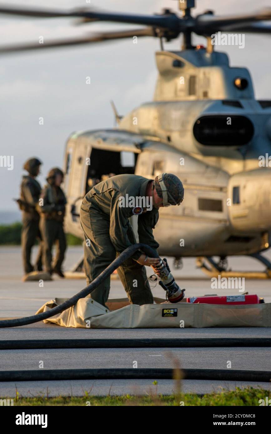 U.S. Marines with 9th Engineer Support Battalion (ESB) complete the refueling of a UH-1Y Venom helicopter during a forward arming and refueling point at Ie Shima, Okinawa, Japan, Sept. 24, 2020. 9th ESB participated in the FARP training to increase their familiarity and coordination with refueling and re-arming while operating in forward locations; The training was executed in cooperation with Marine Light Attack Helicopter Squadron (HMLA) 469, 3rd Transportation Support Battalion (TSB) and Combat Logistics Regiment (CLR) 3. (U.S. Marine Corps photo by Cpl. Ethan M. LeBlanc) Stock Photo