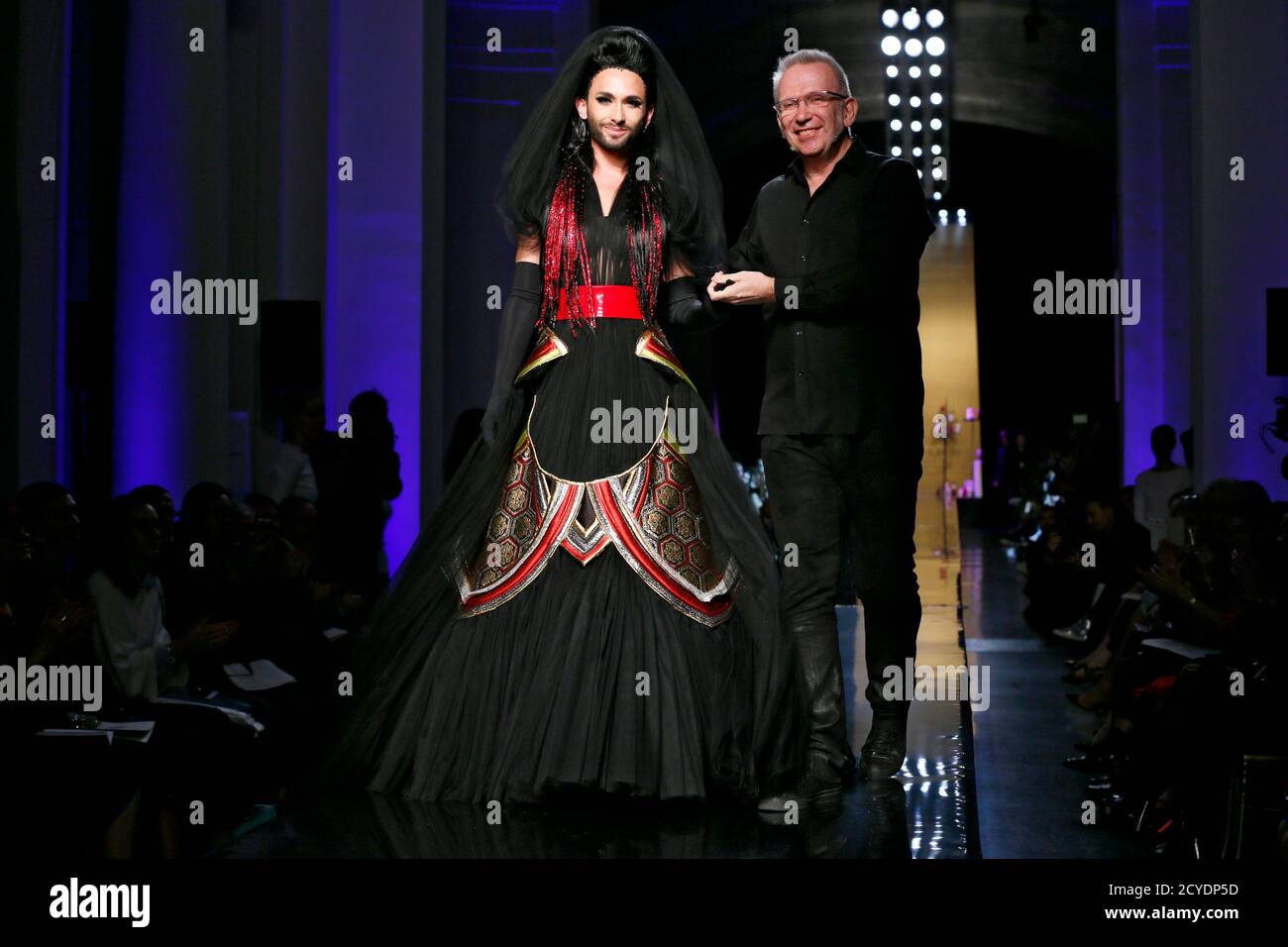 French designer Jean Paul Gaultier (R) appears with Eurovision Song Contest  winner Conchita Wurst at the end of his Haute Couture Fall/Winter 2014-2015  fashion show in Paris July 9, 2014. REUTERS/Gonzalo Fuentes (