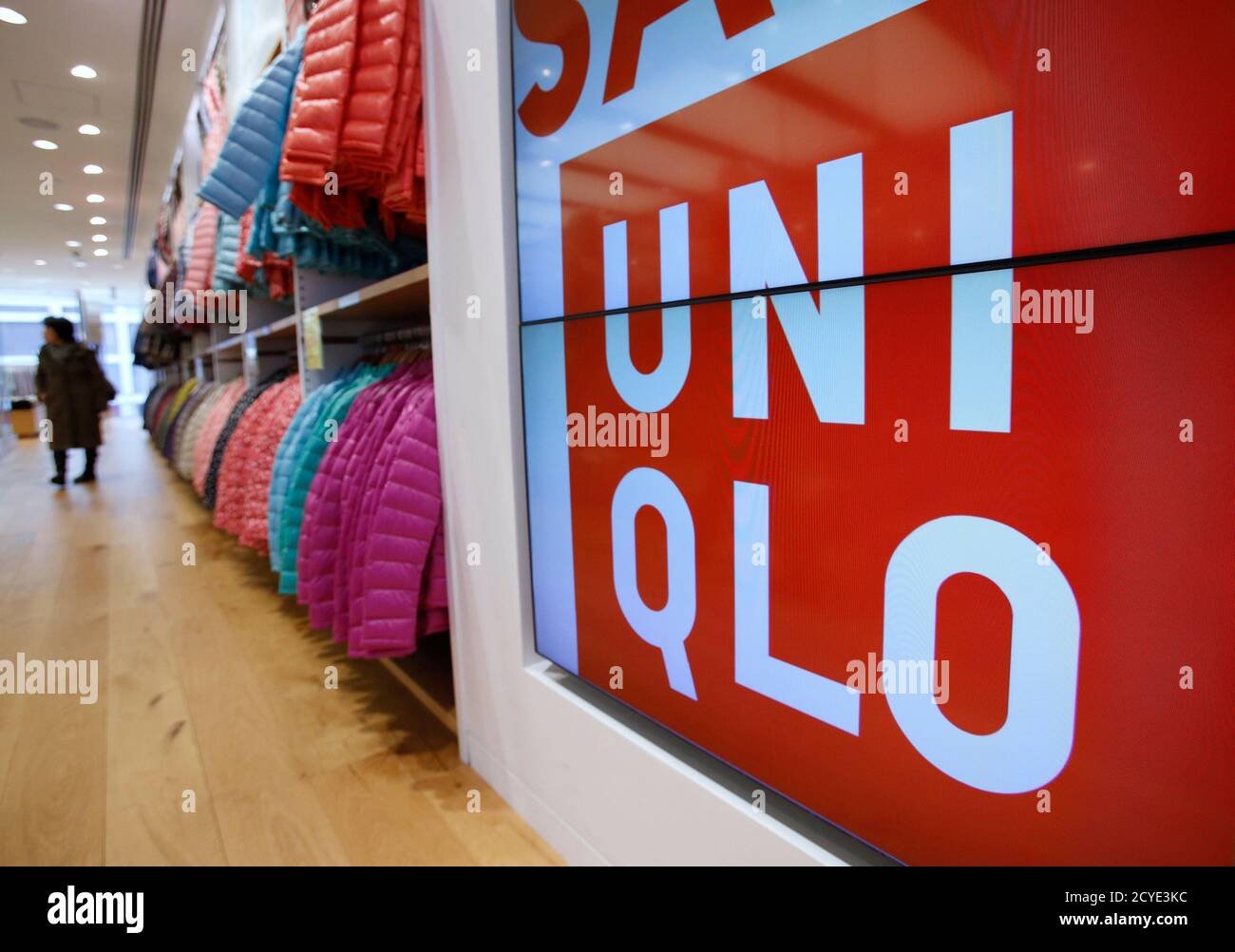 A shopper walks in Fast Retailing's Uniqlo casual clothing store in Tokyo  January 10, 2013. Fast Retailing Co raised its annual profit forecast to a  record high after sales rose at home