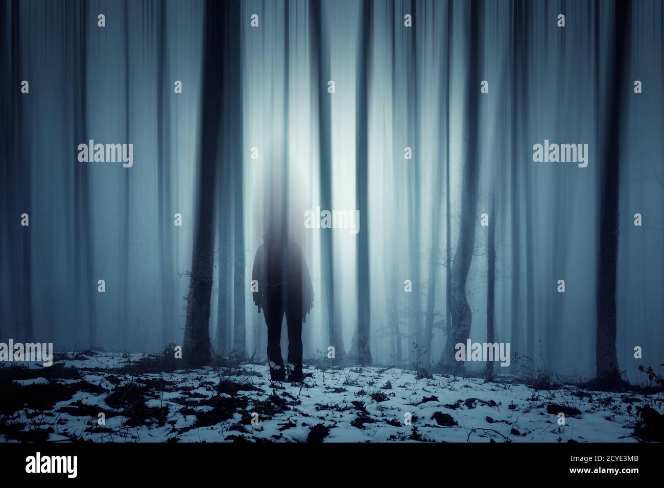 Mysterious man walking through a fairytale forest Stock Photo - Alamy