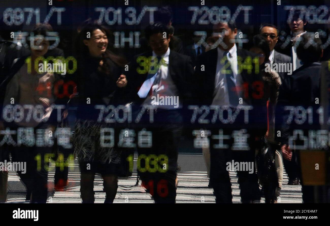 Pedestrians are reflected on a stock quotation board showing stock prices outside a brokerage in Tokyo May 8, 2013. Japanese shares hit a five-year high on Wednesday, buoyed by a record finish on Wall Street and data showing unexpectedly strong industrial orders for Germany, easing concerns over the euro zone's powerhouse. The Nikkei share average climbed 1.4 percent to 14,371.65 by the midday break after hitting as high as 14,376.30, its highest since June 2008, extending the previous session's 3.6 percent rally that came after an extended holiday and last week's strong U.S. jobs data. REUTER Stock Photo