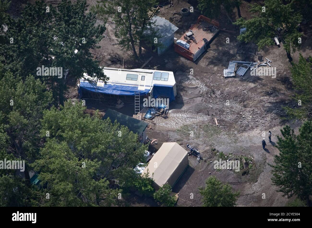 A mobile home lies on its side after flood waters swept through a trailer park in Okotoks, Alberta, south of Calgary June 23, 2013. A couple of trailers were swept downstream when fast-rushing waters from the Sheep River entered the park. Power outages in the Canadian oil capital of Calgary could last for weeks or even months, city authorities said on Sunday, as record breaking flood waters moved downstream to threaten smaller communities in southeastern Alberta.     REUTERS/Andy Clark   (CANADA - Tags: DISASTER ENVIRONMENT) Stock Photo