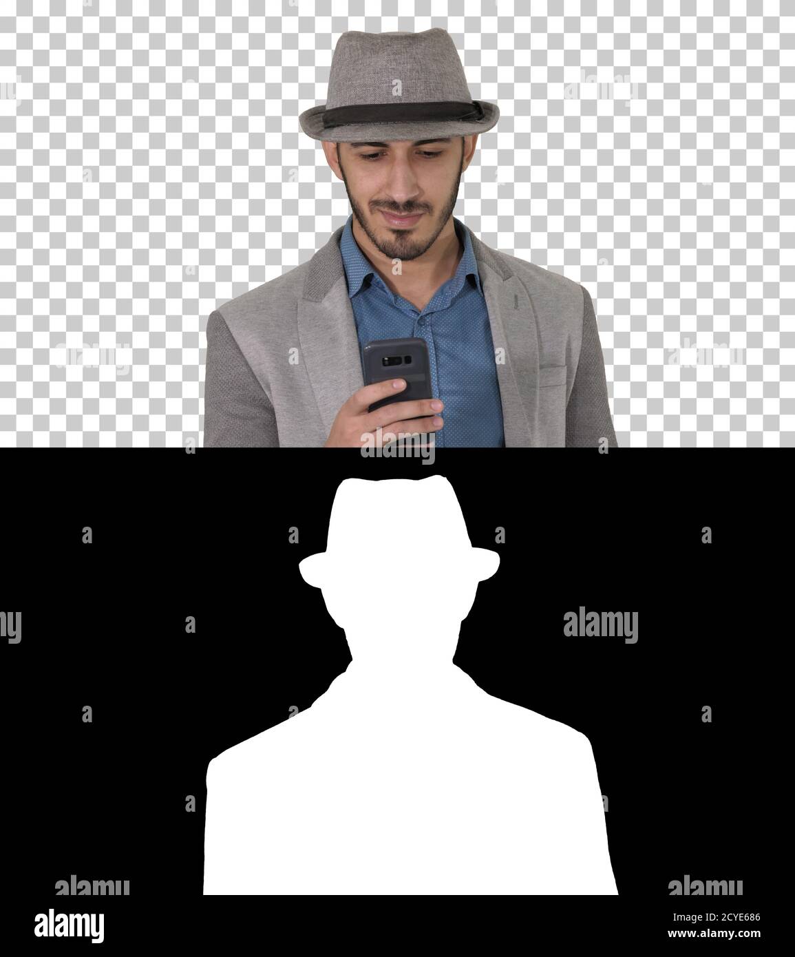 Smart casual arabian man using smartphone while walking, Alpha C Stock Photo