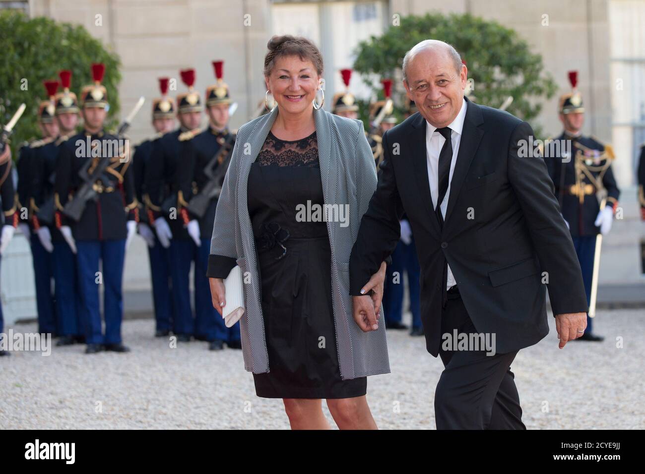 French Defence minister Jean-Yves Le Drian (R) and his wife Maria Vadillo  arrive at the Elysee Palace in Paris, France, to attend a state dinner in  honour of Spain's King and Queen,