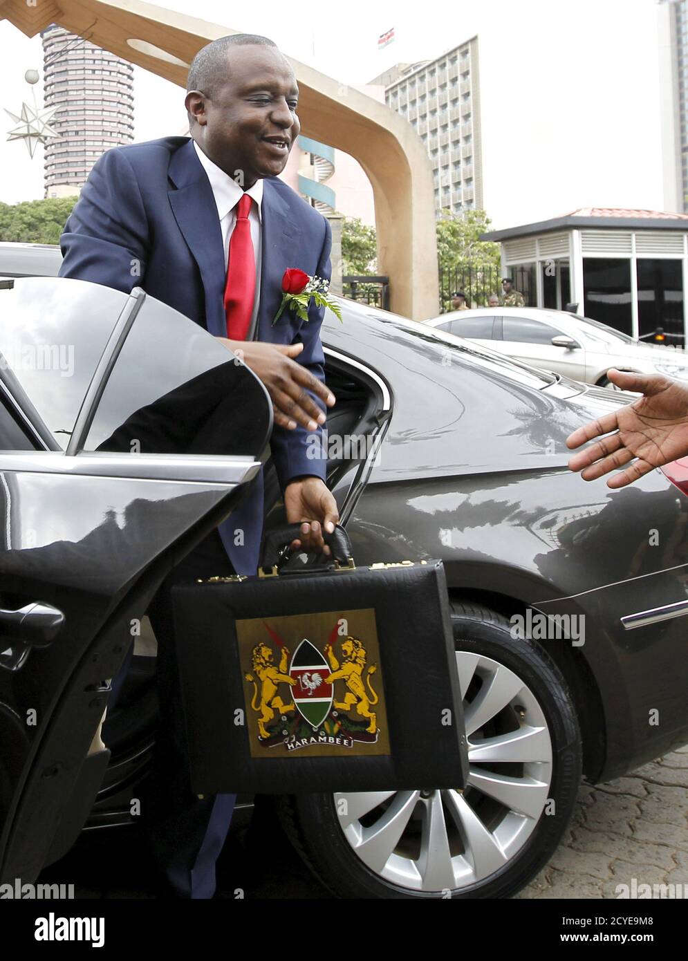 Kenya's Cabinet Secretary of National Treasury (Finance Minister) Henry Rotich carries the briefcase containing the Government Budget for the 2015/16 fiscal year as he arrives at the Parliament buildings in Nairobi, June 11, 2015. The minister said economy growth was 5.3 percent in 2014 and was expected to be between 6.5 to 7 percent in 2015, with the same pace continuing in the medium term. He said growth and employment prospects remained favourable. The budget announcements are coordinated across the East African Community, which comprises Kenya, Tanzania, Uganda, Rwanda and Burundi where th Stock Photo