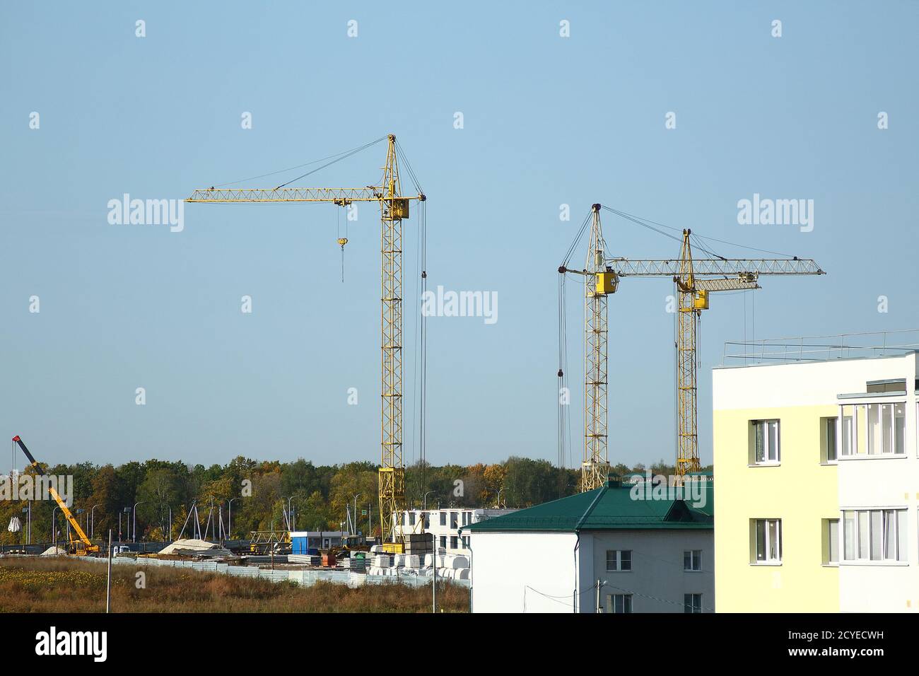 New complex of apartment buildings under construction with yellow ...