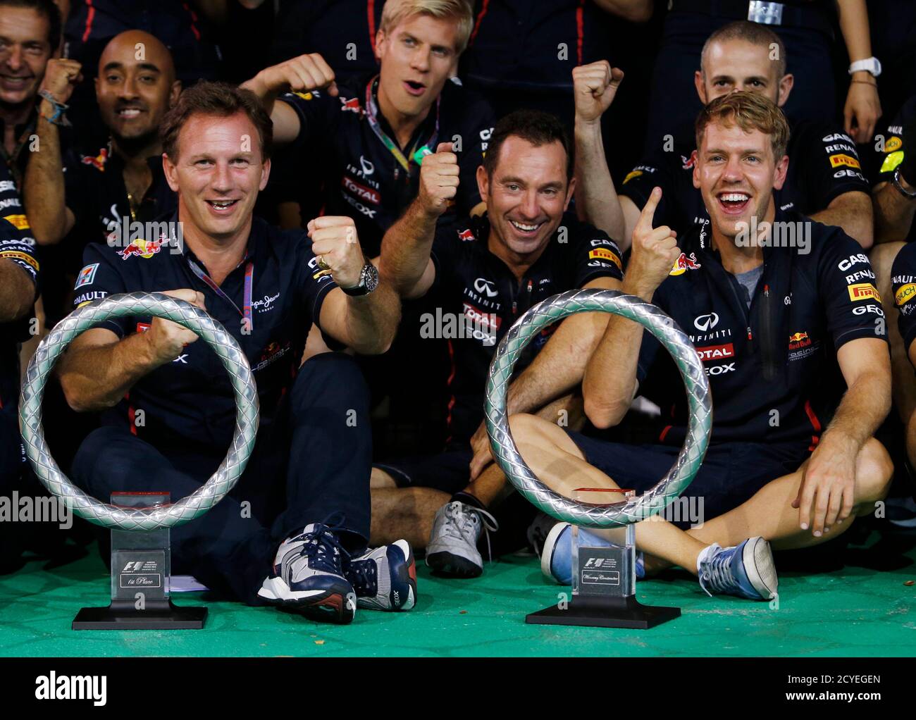 Red Bull Formula One team principal Christian Horner (L), front end  engineer Ole Schack and Red Bull Formula One driver Sebastian Vettel of  Germany (R) pose for a group photo after the