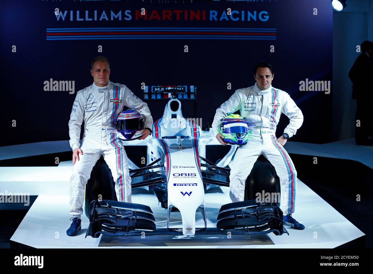 Drivers Felipe Massa (R) of Brazil and Valtteri Bottas of Finland pose for photographers at the launch of the new livery for the Williams-Martini Formula One motor racing car in London, England March 6, 2014. Italian spirits brand Martini will become the main sponsor of the Williams Formula One motor racing team this season, with the company logo featuring on a new predominantly white car.  REUTERS/Eddie Keogh (BRITAIN - Tags: SPORT MOTORSPORT F1) Stock Photo