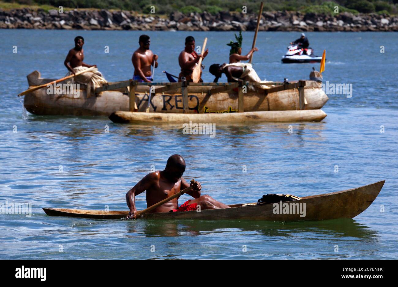 Fahrenheit Chemie pindas A policeman on a jet-ski watches as traditionally dressed representatives  from South Pacific nations paddle their canoes as they prepare to  participate in a protest aimed at ships leaving the Newcastle coal
