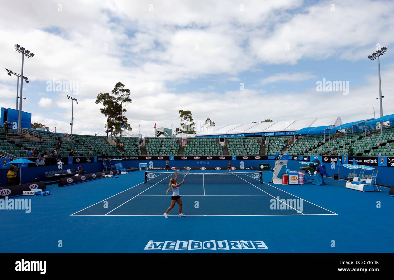 Dominika Cibulkova of Slovakia serves to Ana Ivanovic of Serbia during a  practice session before the Australian Open tennis tournament in Melbourne  January 15, 2012. REUTERS/Mark Blinch (AUSTRALIA - Tags: SPORT TENNIS