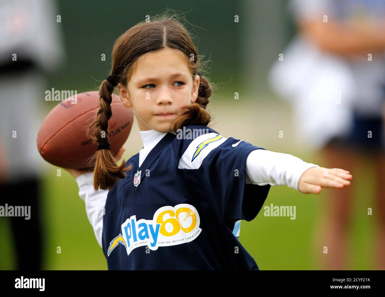 Seven-year-old Megan Johnson of Manhattan Beach throws the ball in the Punt, Pass & Kick competition prior to the Cincinnati Bengals playing against the San Diego Chargers in their NFL football game in San Diego, California December 2, 2012. Punt, Pass & Kick competition in five age gendered groups with the top scorer in each group crowned team champion, the top four scorers from all the teams compete for the National Championships to be held during an NFC playoff game.   REUTERS/Alex Gallardo (UNITED STATES) Stock Photo